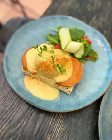 V-eggs Benedict on a blue plate