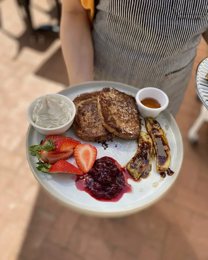 French Toast with caramelised bananas, strawberries and berry compote